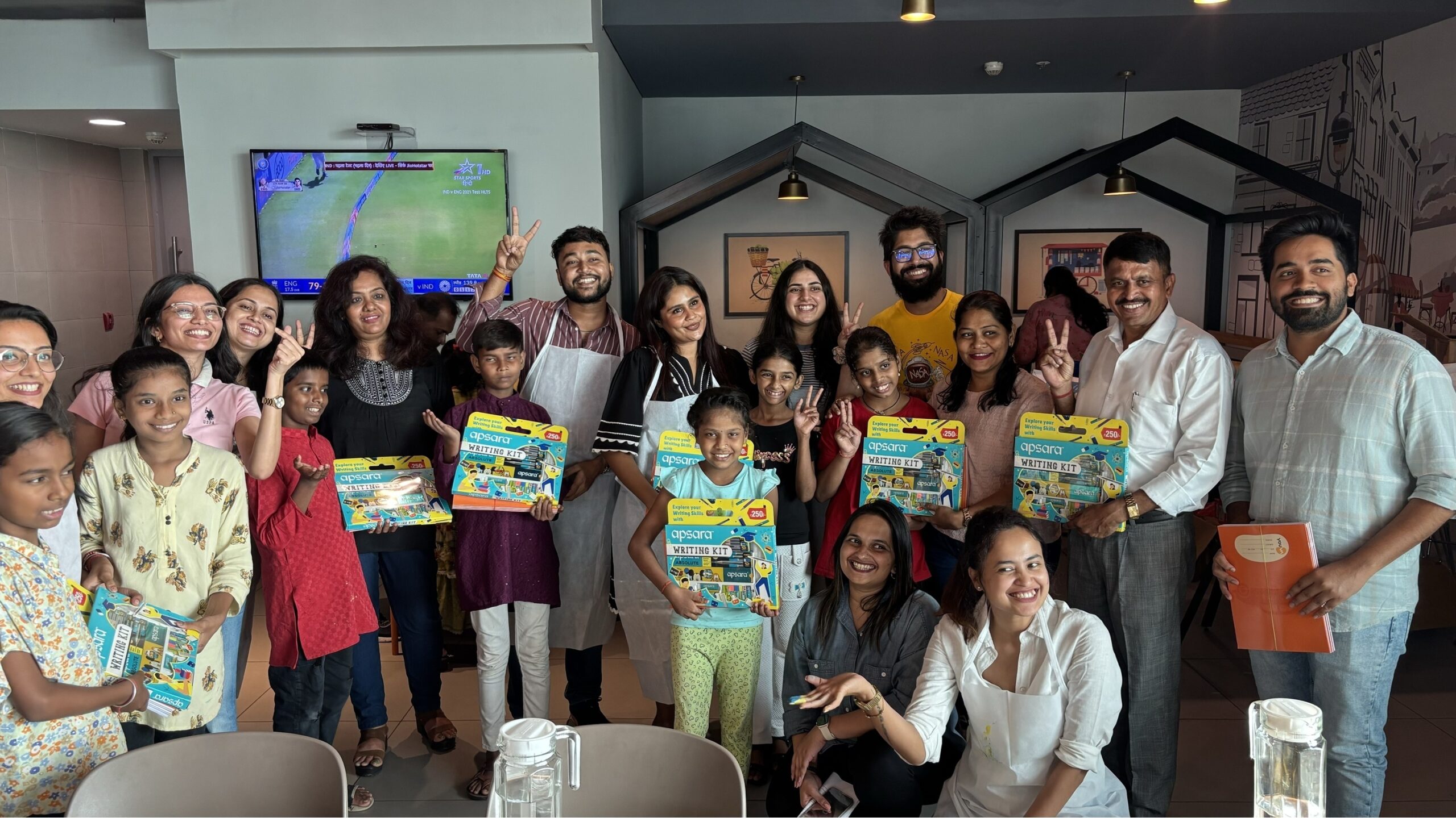Employees of K Raheja Corp with students at the Back to School campaign scaled