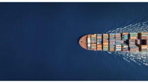 Aerial top down view of a large container cargo ship with copy space