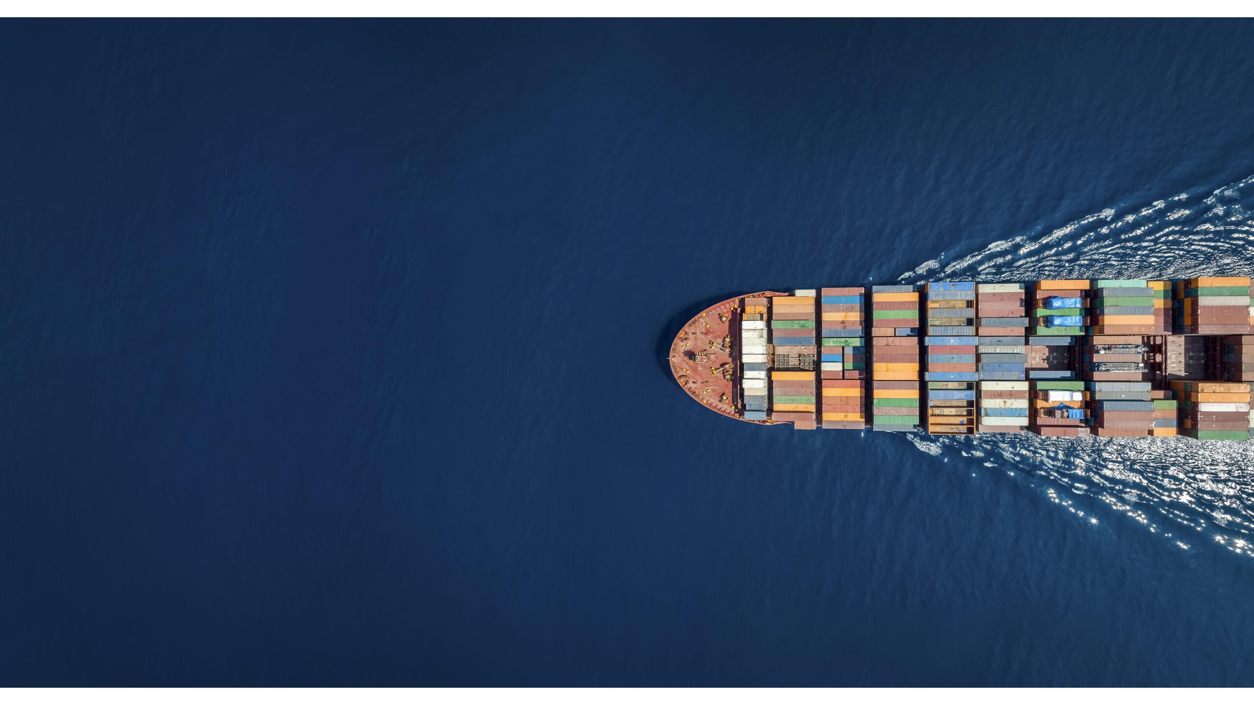 Aerial top down view of a large container cargo ship with copy space