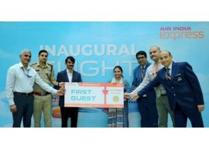 Dignitaries and the Air India Express team present ceremonial boarding passes to the first guests from Bhopal