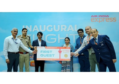 Dignitaries and the Air India Express team present ceremonial boarding passes to the first guests from Bhopal